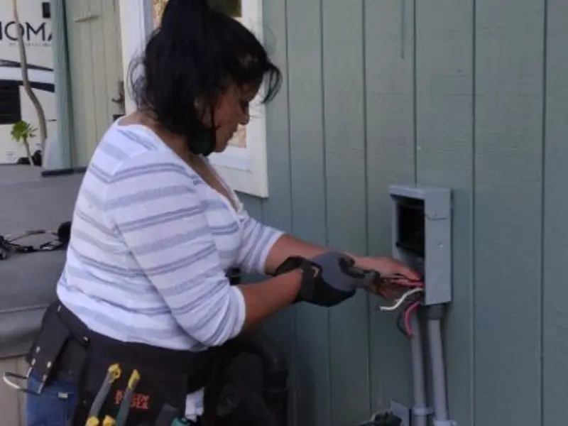 Licensed electrician wiring an exterior subpanel in Murrieta